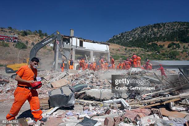 Rescue workers search for the victims in the wreckage of a girls' school dormitory in Konya August 1, 2008. A gas explosion killed at least 17 female...