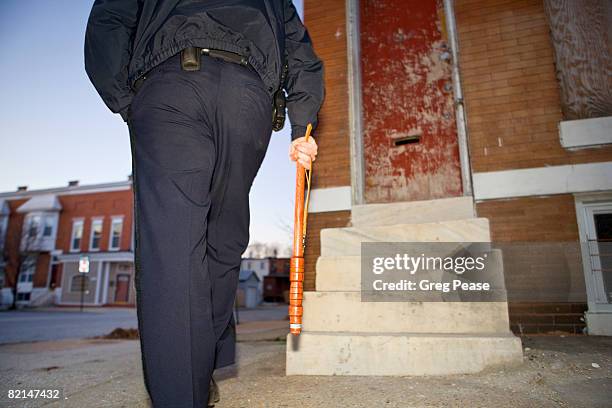 policeman patrolling neighborhood on foot - baltimore-slums stock pictures, royalty-free photos & images