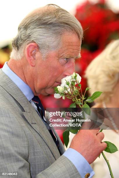 Prince Charles, Prince of Wales smells a rose at Sandringham Flower Show on July 30, 2008 in Sandringham, England.