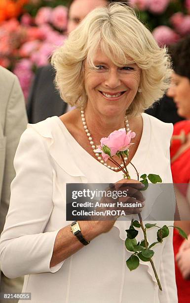 Camilla, Duchess of Cornwall smells a rose during a tour of Sandringham Flower Show on July 30, 2008 in Sandringham, England.