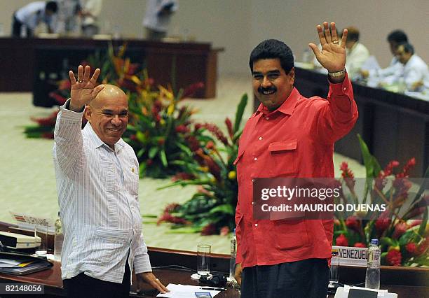 Venezuela's Interior Minister Ramon Rodriguez Chacin and Foreign Minister Nicolas Maduro wave to journalist upon their arrival to the summit on drugs...