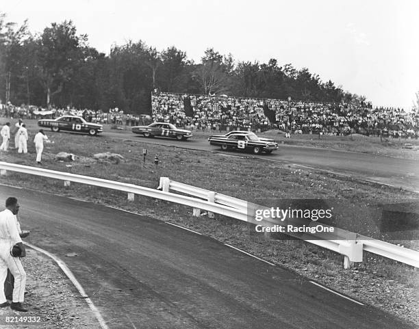Roy Tyner leads Ned Jarrett and Bernie Alvarez at Watkins Glen in 1964. Billy Wade won, making it four straight for him on the NASCAR Cup Series...
