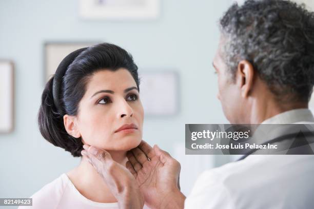african male doctor examining patient - thyroid exam stock pictures, royalty-free photos & images