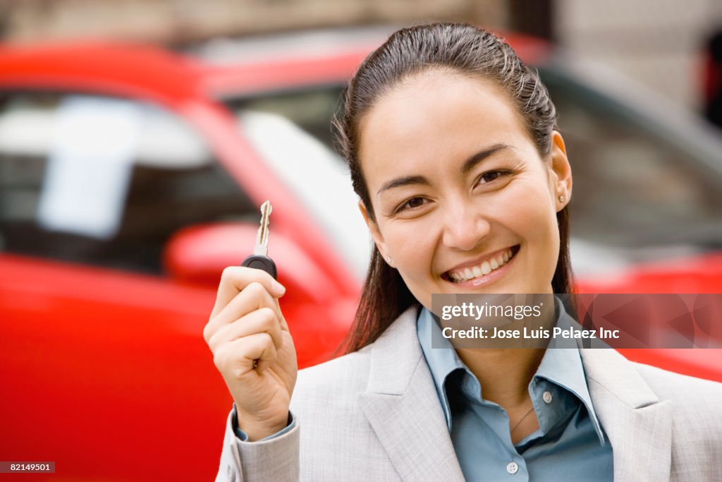 Asian woman holding car key