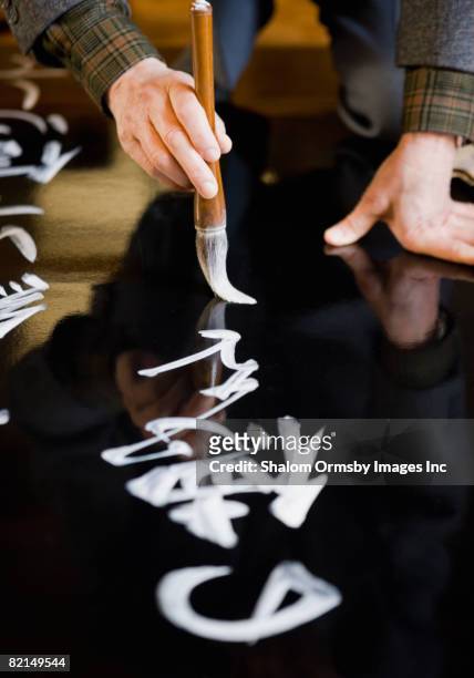 senior asian man writing japanese calligraphy - kanji stock pictures, royalty-free photos & images