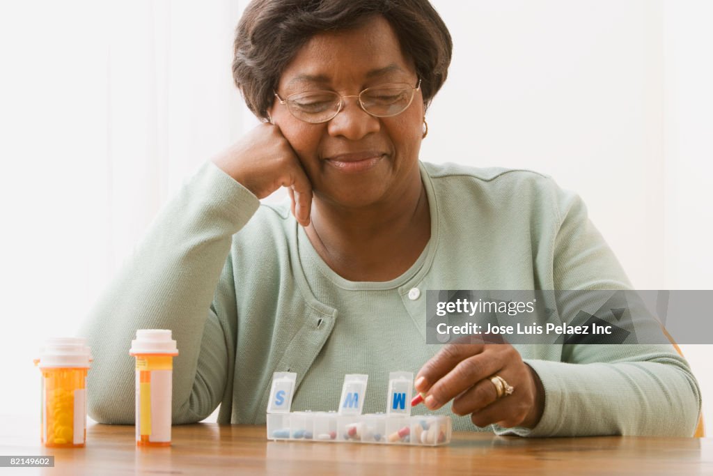 Senior African woman taking medication