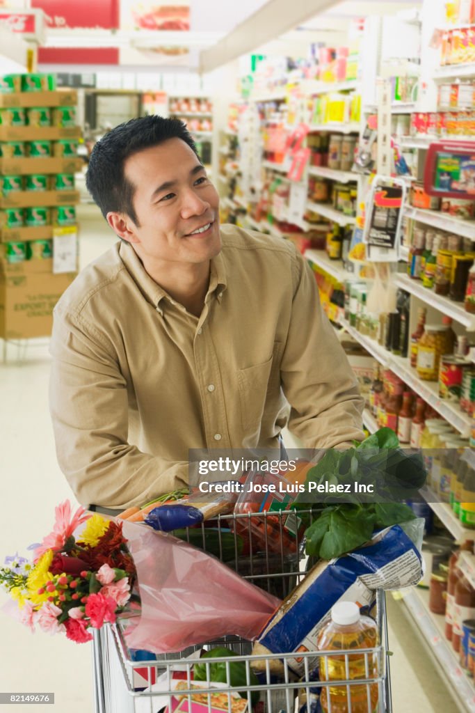 Asian man grocery shopping