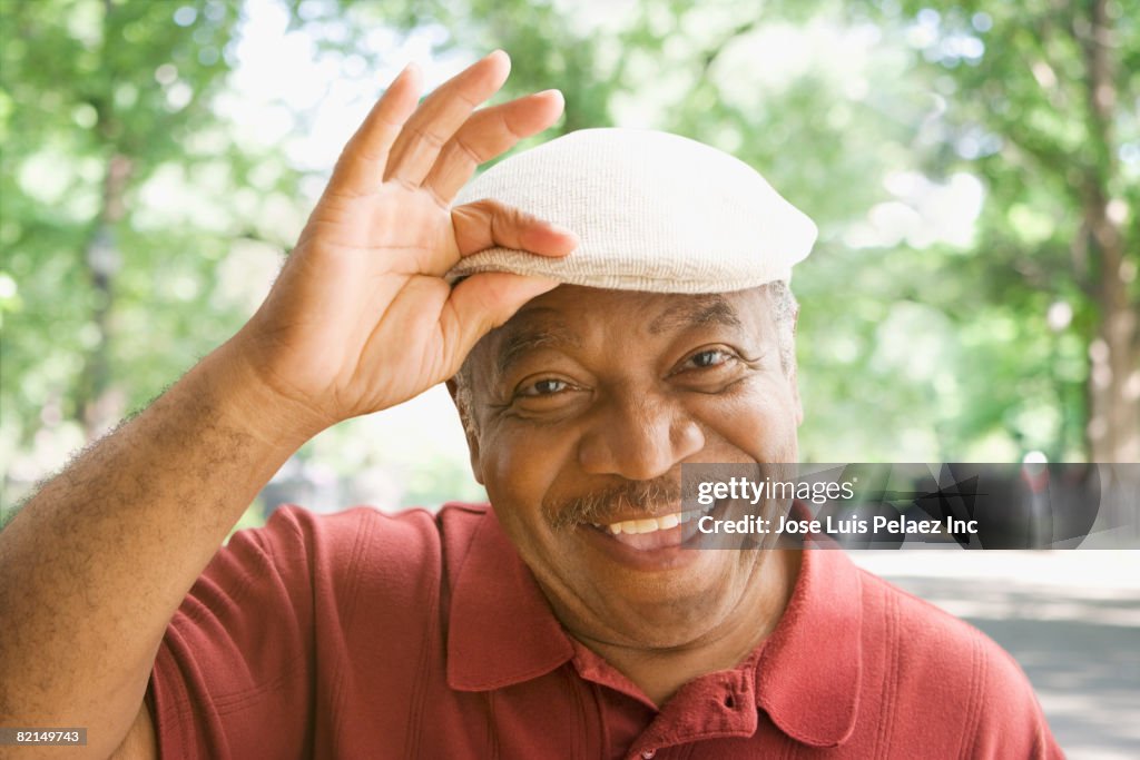 Senior African man tipping hat