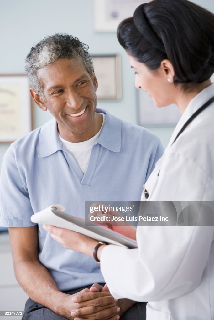 Middle Eastern female doctor talking to patient