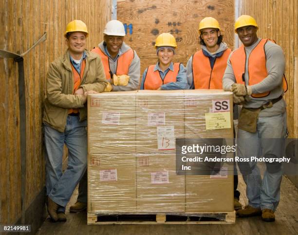 multi-ethnic warehouse workers next to shipment - vakuumförpackad bildbanksfoton och bilder
