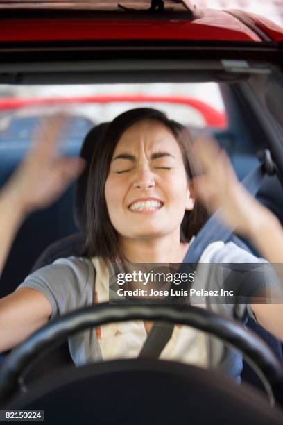 frustrated asian woman driving car - man driving anxiously stock-fotos und bilder