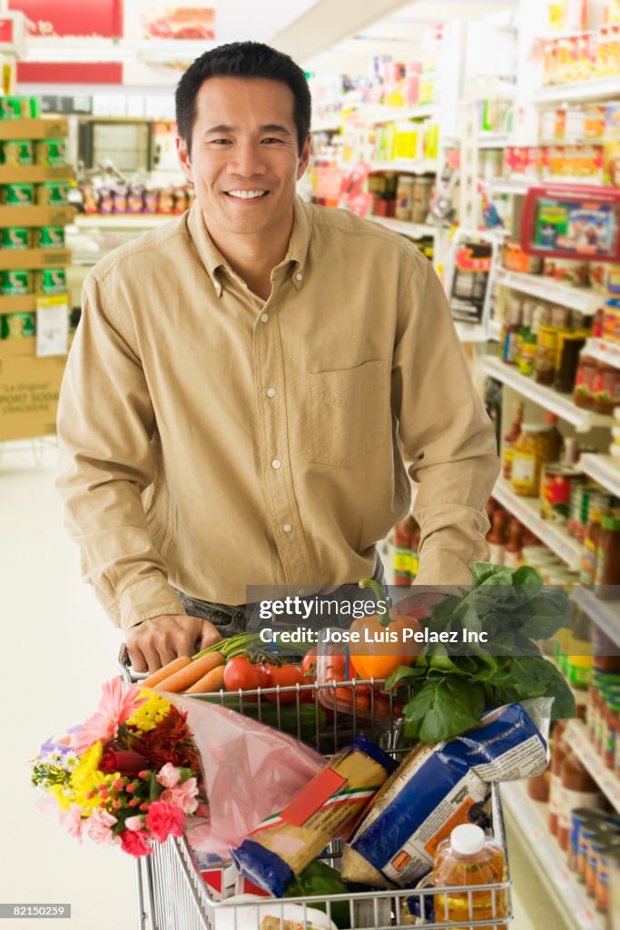 Asian man grocery shopping