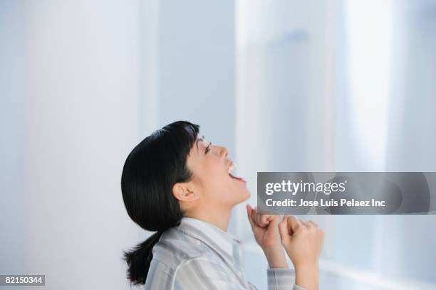 asian businesswoman cheering - mouth open profile stock pictures, royalty-free photos & images