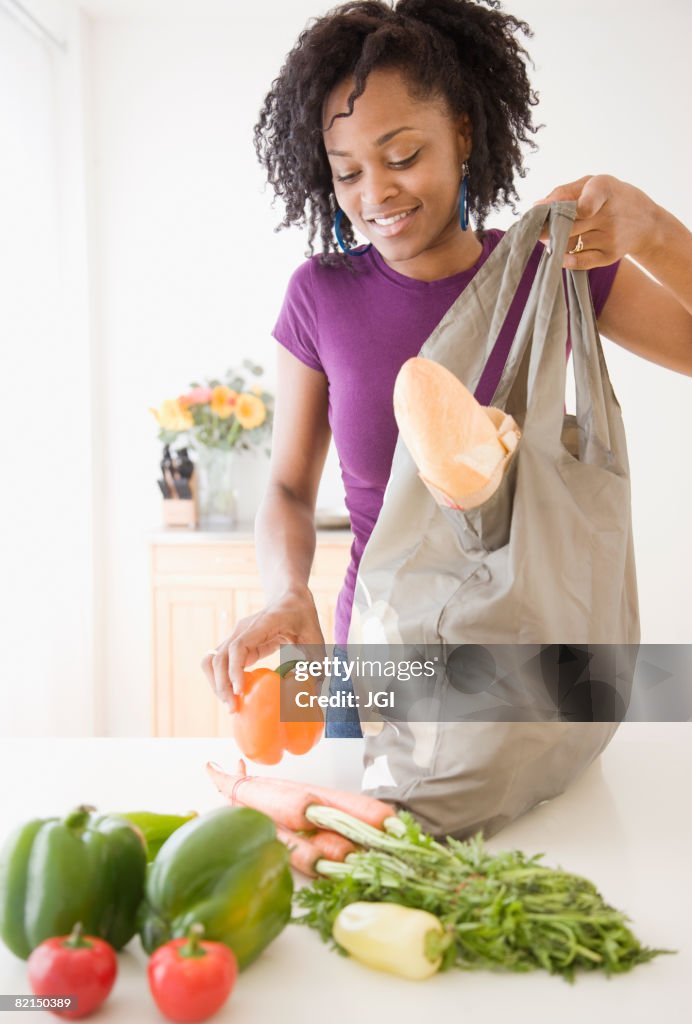 African woman unpacking groceries