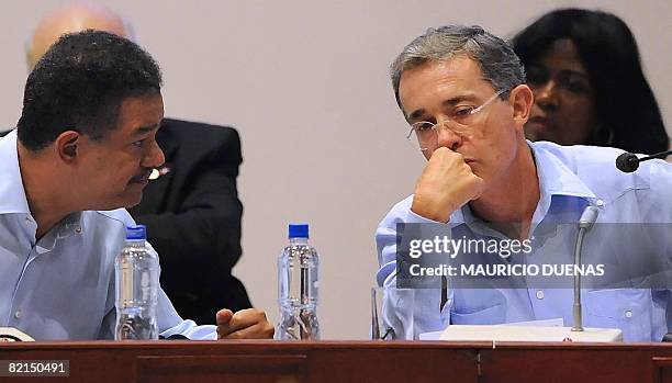 Dominican Republic's President Leonel Fernandez speaks with his Colombian counterpart Alvaro Uribe during the summit on drugs and security on August...