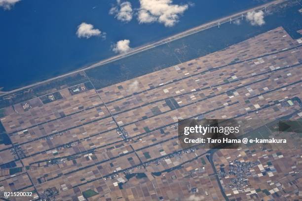 fields in tahara city in aichi prefecture in atsumi peninsula daytime aerial view from airplane - atsumi stockfoto's en -beelden