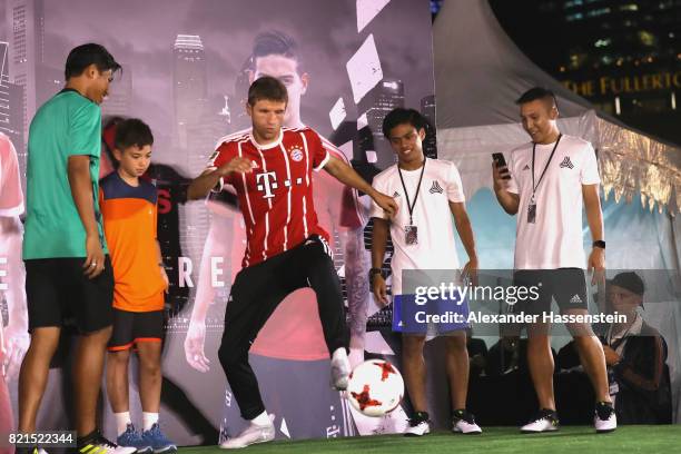 Thomas Mueller of FC Bayern Muenchen shows football skills during a adidas marketing event at Clifford square during the Audi Summer Tour 2017 on...