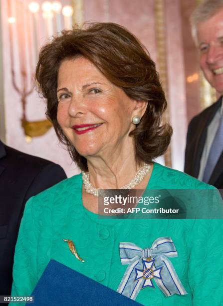 Queen Silvia of Sweden smiles after she was awarded the Bavarian Order of Merit at the Prinz-Carl-Palais in Munich, southern Germany, on July 24,...