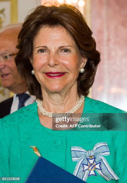 Queen Silvia of Sweden smiles after she was awarded the Bavarian Order of Merit at the Prinz-Carl-Palais in Munich, southern Germany, on July 24,...