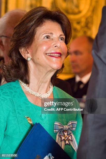 Queen Silvia of Sweden smiles after she was awarded the Bavarian Order of Merit at the Prinz-Carl-Palais in Munich, southern Germany, on July 24,...