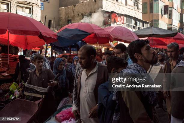 People navigate a busy street in the bazaar in Kabul's old city neighborhood on July 20, 2017 in Kabul, Afghanistan. Despite a heavy security...