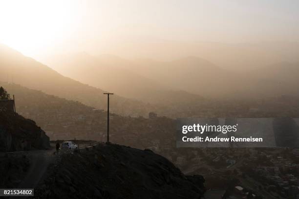 The sun sets over homes on July 20, 2017 in Kabul, Afghanistan. Despite a heavy security presence throughout the city, life remains under constant...