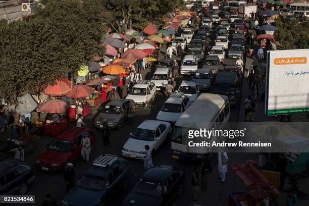 Cars attempt to manoeuvre a traffic jam during rush hour on July 23, 2017 in Kabul, Afghanistan. Despite a heavy security presence throughout the...