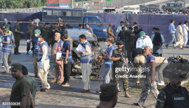 Pakistani security officials inspect the bomb blast site in Lahore, Pakistan on July 24, 2017. At least 26 people were killed and 49 injured on a...