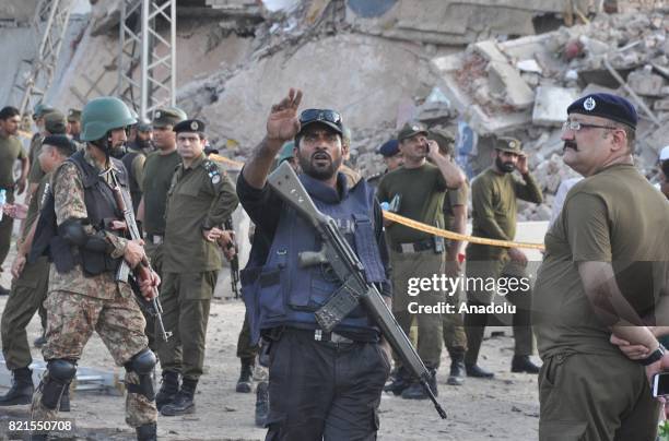 Pakistani soldiers take security measures at the bomb blast site in Lahore, Pakistan on July 24, 2017. At least 26 people were killed and 49 injured...