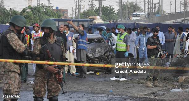 Pakistani security officials inspect the bomb blast site in Lahore, Pakistan on July 24, 2017. At least 26 people were killed and 49 injured on a...