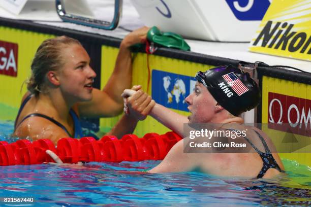 Lilly King of the United States celebrates finishing 1st with 2nd place finisher Ruta Meilutyte of Lithuania in the Women's 100m Breaststroke...