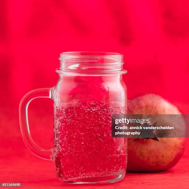 jar with grenadine and carbonated water. pomegranate. - glas bottle imagens e fotografias de stock