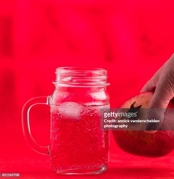 jar with grenadine and carbonated water. pomegranate. - glas bottle imagens e fotografias de stock