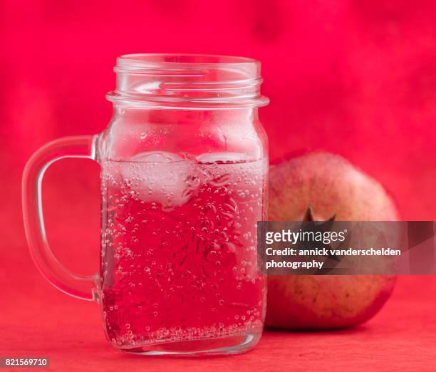 jar with grenadine and carbonated water. pomegranate. - glas bottle imagens e fotografias de stock