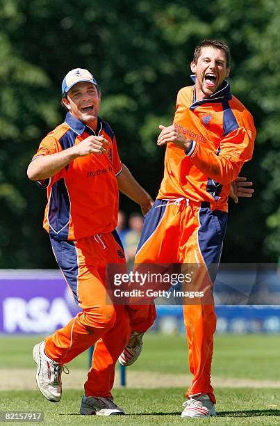 Netherland's bowler Pieter Seelarr celebrates with Peter Borren after bowling out Kenya's Steve Tikolo during the Kenya and Netherlands - ICC World...