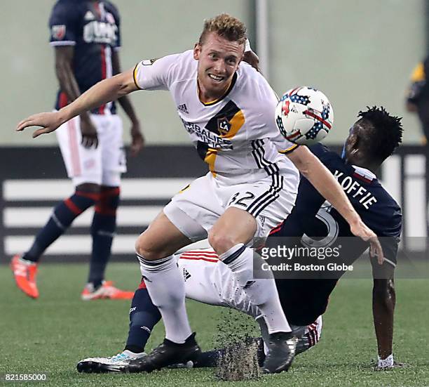 New England Revolution's Gershon Koffie loses control of the ball to Los Angeles Galaxy's Jack McBean during the first half. The New England...