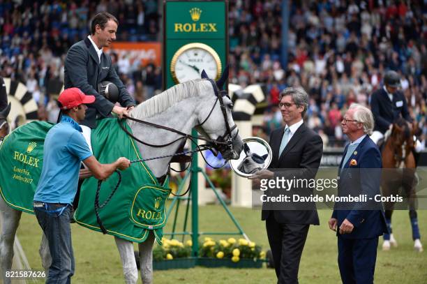 Awards ceremony the winner Gregory Wathelet of Belgium, riding Coree, Horse is mirrored in its award, during Rolex Grand Prix CHIO World Equestrian...