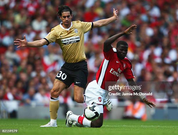 Tiago Mendes of Juventus challenges Emmanuel Eboue of Arsenal during the pre-season friendly match between Arsenal and Juventus during the Emirates...