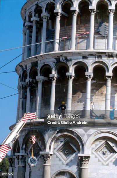 Special steel cables, in place since 1992, encase a tier of the Leaning Tower of Pisa March 2001 above workers who are restoring the Italian landmark...