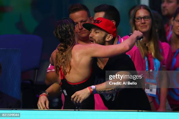 Katinka Hosszu of Hungary celebrates winning gold in the Women's 200m Individual Medley Final with her husband Shane Tusup on day eleven of the...