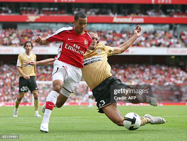 Arsenal's footballer Theo Walcott takes on Juventus's Giorgio Chiellini during the Emirates Cup football competition at the Emirates stadium in north...