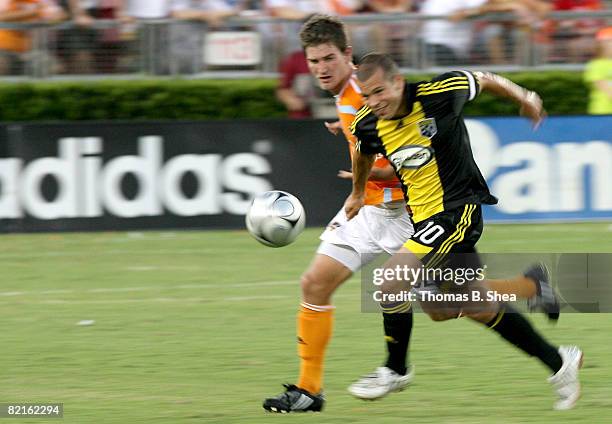 Bobby Boswell of the Houston Dynamo fights for the ball against Alejandro Moreno of Columbus Crew on August 02, 2008 at Robertson Stadium in Houston,...