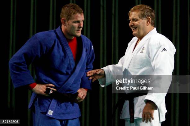 Head coach Peter Herrmann of the Australian Judo team talks with team member Daniel Kelly during a practice session at the Beijing Science and...