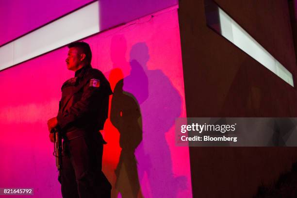 Police officer stands guard outside after a shooting victim was brought to the General Hospital in Cancun, Mexico, on Tuesday, July 11, 2017. The...