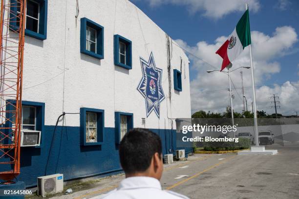 Mexican flag flies outside a police station in Cancun, Mexico, on Wednesday, July 12, 2017. The narco-traffickers already hold sway over swaths of...