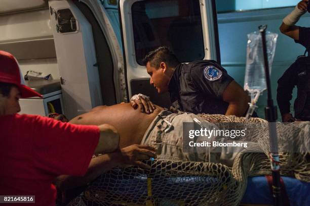 Paramedics unload a patient injured in a shooting at the General Hospital in Cancun, Mexico, on Tuesday, July 11, 2017. The narco-traffickers already...