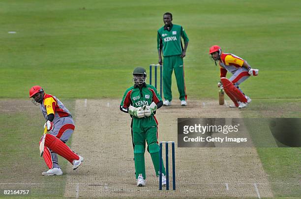 Morris Ouma Amolo wicket keeper of Kenya, awaits a throw as Sanjay Thuraisingam and Karun Jethi of Canada run the wickets during the Kenya v Canada...