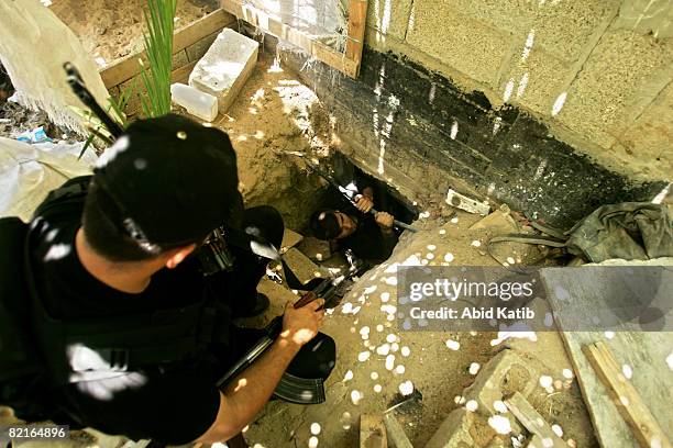 Palestinian policemen loyal to Hamas inspect a tunnel under a house belonging to a family of Helis clan as they sweep the area, one day after clashes...