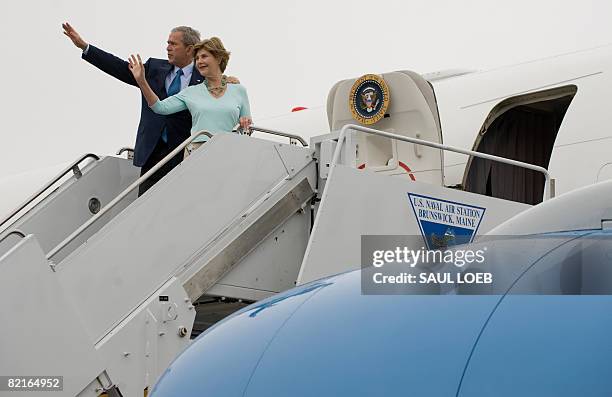 President George W. Bush and First Lady Laura Bush wave from Air Force One prior to departing from Sanford Regional Airport in Sanford, Maine, on...