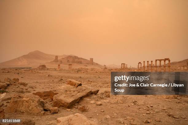 sandstorm at dawn over palmyra, syria. - vestige antique photos et images de collection